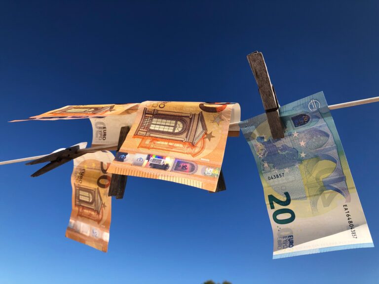 Euro banknotes pegged to a clothesline drying in the sun. Money laundering concept