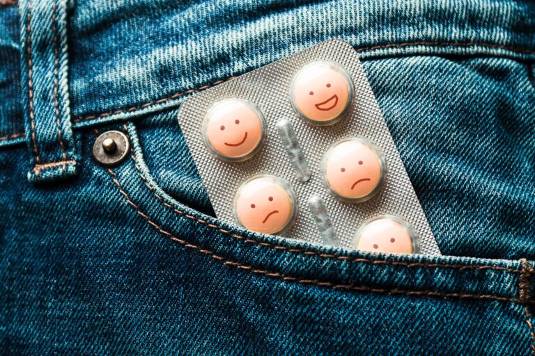 Pills in the jeans pocket. Concept of antidepressants