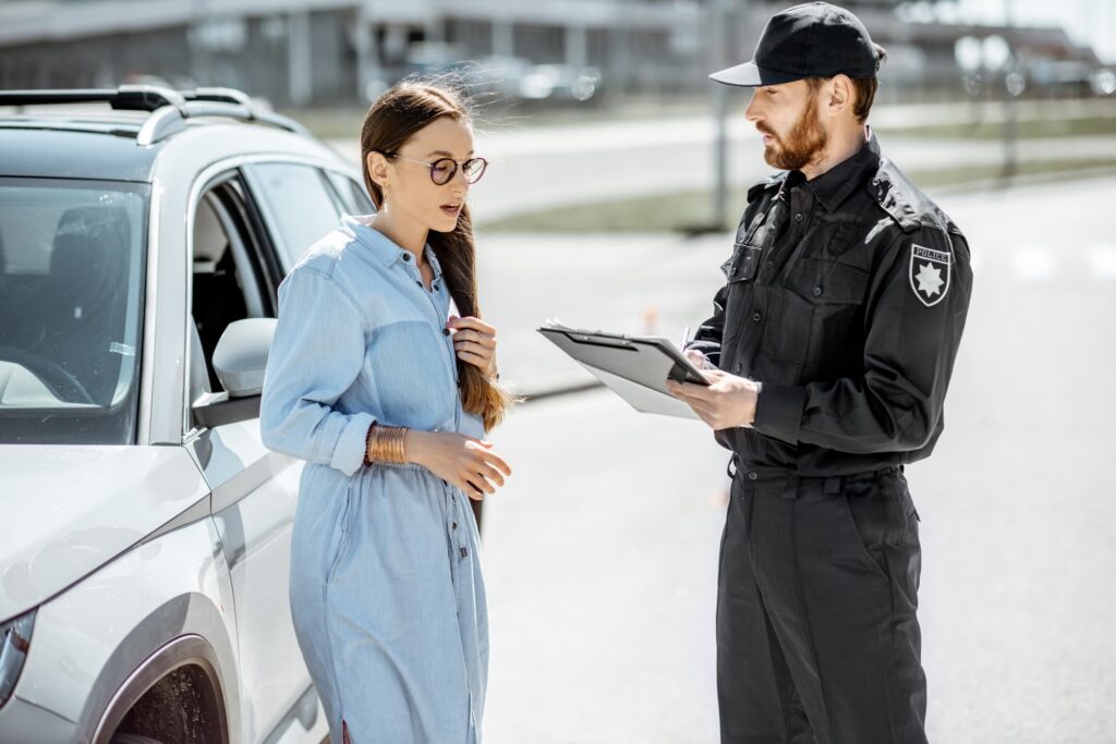 Policeman with female driver on the roadside