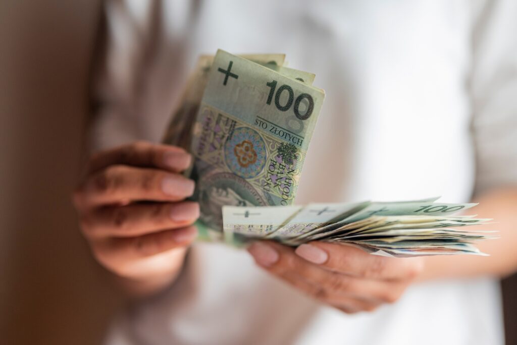 Polish money banknotes in the hands of a girl
