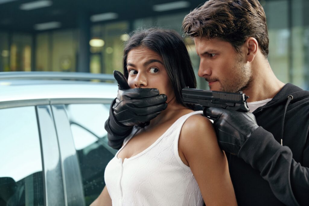 Robber threatening with pistol to scared girl