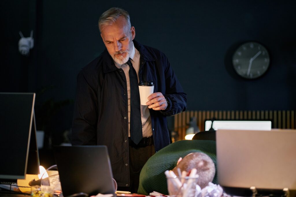 Businessman Holding Coffee Cup at Office Desk