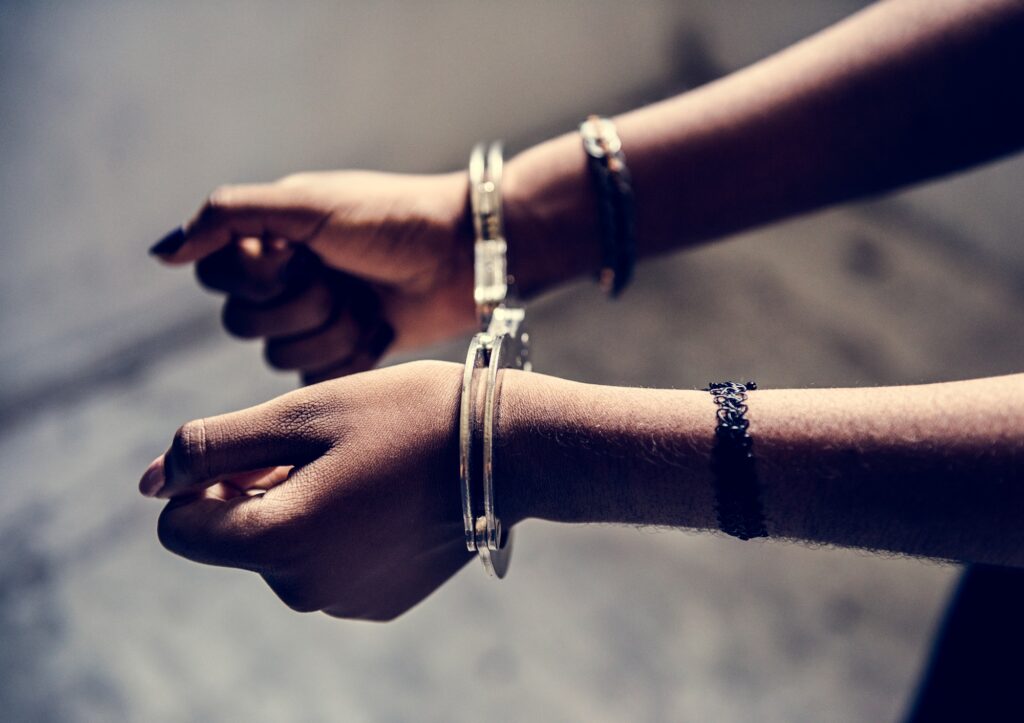 Closeup of arrested hands with handcuffs