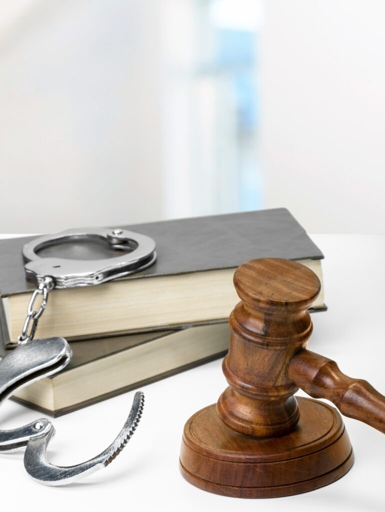 Gavel, books and handcuffs