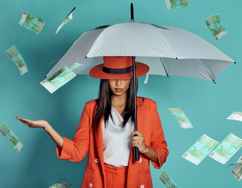 Money, fashion and rich lady being showered by cash while holding umbrella for insurance, protectio