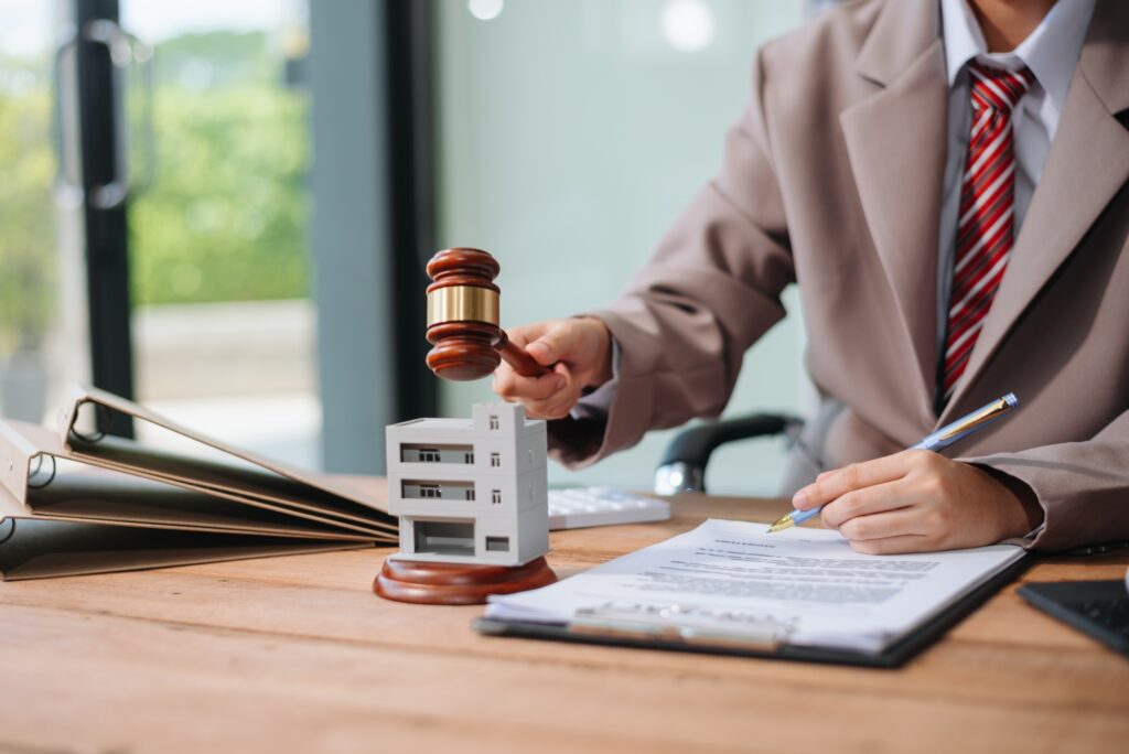 Real Estate Lawyer And House Foreclosure Law. House model, hammer judge gavel on table